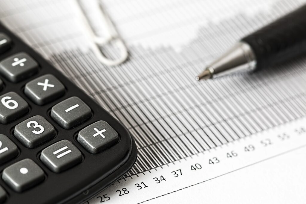 A calculator sits on top of a sheet of paper.