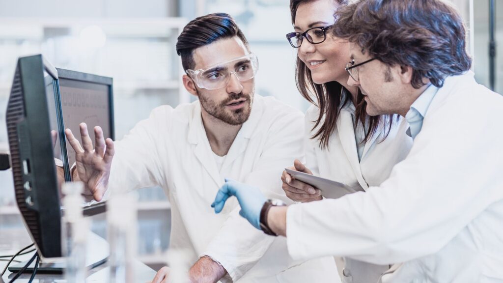 Scientists discussing in the laboratory, using computer