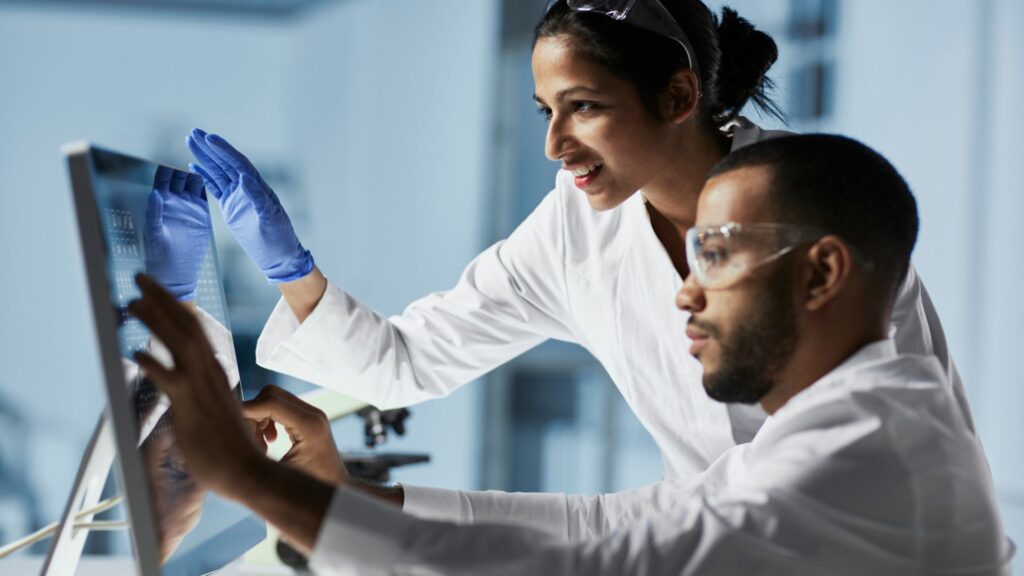 Scientists Working on Computer In Modern Laboratory