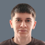 A young adult with short brown hair, light skin, and a neutral expression, wearing a dark crew neck shirt, facing forward against a plain gray background—representing the professionalism of Delta4's team.