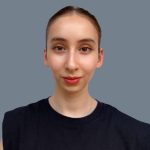 A young person with light skin and brown hair pulled back, wearing a black sleeveless top, poses confidently against a plain gray background—perfect for showcasing Delta4's team style.